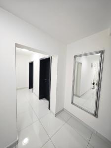 a white room with a mirror on the wall at Agron in Brčko