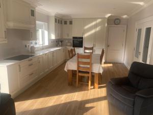 a kitchen with a table and chairs and a couch at Spacious 5 bedroom house in Buncrana in Buncrana