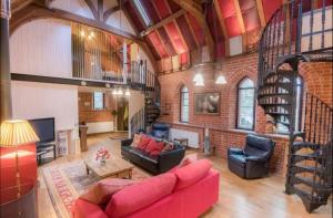 sala de estar con sofá rojo y pared de ladrillo en Curbridge Chapel, en Southampton