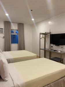 Postel nebo postele na pokoji v ubytování ILOILO GRAND HOTEL