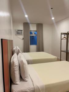 Postel nebo postele na pokoji v ubytování ILOILO GRAND HOTEL