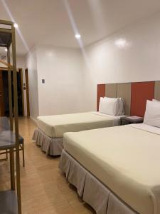 Postel nebo postele na pokoji v ubytování ILOILO GRAND HOTEL