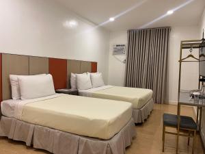Postel nebo postele na pokoji v ubytování ILOILO GRAND HOTEL
