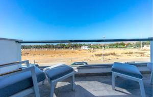 a balcony with chairs and a view of a construction site at Amazing Home In San Javier in San Javier +32 photos