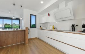 a kitchen with white walls and a wooden counter at Amazing Home In San Javier in San Javier