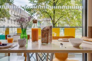 ein Holztisch mit Speisen und Getränken darauf in der Unterkunft Auberge de Jeunesse Barbey - Youth Hostel Bordeaux in Bordeaux