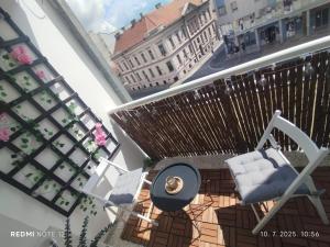 a view of a balcony with a table and chairs at Centar Novi Sad in Novi Sad