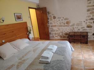 a bedroom with a bed with two towels on it at Fonda Angeleta in Valderrobres