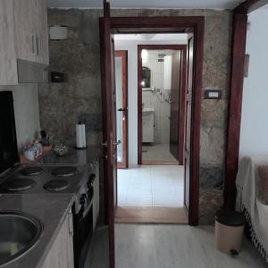 a kitchen with a door leading to a bathroom at Planinska kuća Bukulja in Arandelovac +34 photos