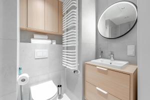 a small bathroom with a sink and a mirror at Noli Gdansk Old Town in Gdańsk +80 photos
