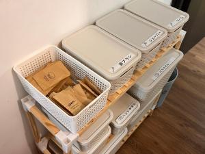 a drawer filled with white baskets and boxes at VACANCE APARTMENTs in Ho Chi Minh City