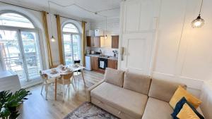 a living room with a couch and a table at Stylish 2-Bedroom Flat in Barbican Centre near Farringdon with Rooftop Terrace in London