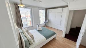a bedroom with a bed and a large window at Stylish 2-Bedroom Flat in Barbican Centre near Farringdon with Rooftop Terrace in London