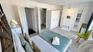 a living room with a bed and a green chair at Stylish 2-Bedroom Flat in Barbican Centre near Farringdon with Rooftop Terrace in London