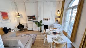 a living room with a couch and a table at Stylish 2-Bedroom Flat in Barbican Centre near Farringdon with Rooftop Terrace in London +17 photos