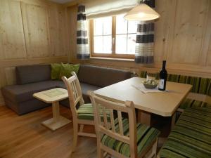 a living room with a table and a couch at Ferienwohnung Salzgeber in Tschagguns