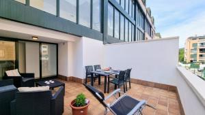 a balcony with a table and chairs on a building at Apartamento Serenity in Posada de Llanes