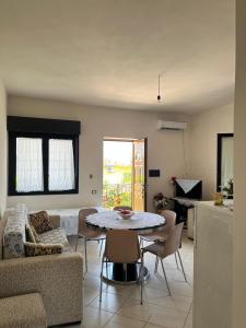 a living room with a table and a couch at Holiday home in Vlorë