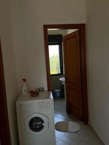 a washer and dryer in a room with a door at Holiday home in Vlorë