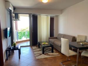 a living room with a couch and a table at Apartments Palma in Dobra Voda