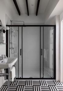 a bathroom with a glass door with a sink at White Hart Hotel in Dorchester on Thames +96 photos