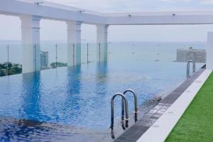 a swimming pool on the roof of a building at Skyline Stay - Empire Tower in Jomtien Beach