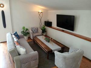 a living room with couches and a flat screen tv at Casa Else in Massa Lubrense