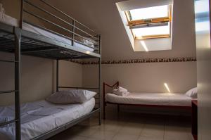 two bunk beds in a room with a skylight at La Casa di Lucia in Marcelli