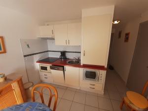 Kuchyňa alebo kuchynka v ubytovaní SAVANNA BEACH I Joli T2 avec vue mer piscine Cap d'Agde