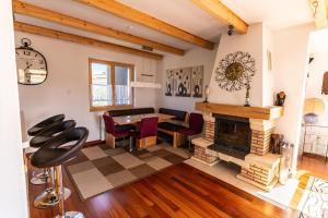 a living room with a fireplace and a table and chairs at Apartment Stefanija in Ankaran