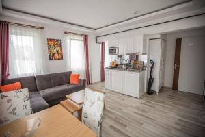 a living room with a couch and a kitchen at Air Suite Hotel in Trabzon