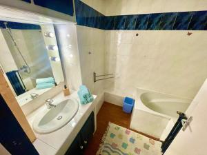 a bathroom with a sink and a bath tub at " Douceur Jasmin " Balcon - 7 pers - Wifi - TV in Ramonville-Saint-Agne +24 photos