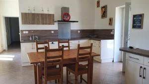 a kitchen with a wooden table and chairs at Maison spacieuse proche de Saint-Emilion in Ruch +11 photos