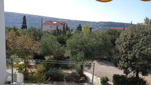 a view of a garden with bushes and trees at Apartments in Barbat - Insel Rab 17610 in Barbat na Rabu