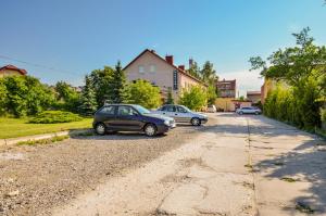 a couple of cars parked on a dirt road at U Michała in Kielce