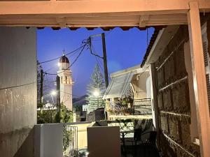 a view of a building with a clock tower at Vintage House, a Traditional Zakynthian Home in central Zante Town by Villa Mana Gers in Zakynthos Town