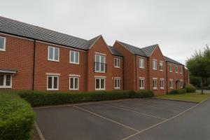 a row of brick houses in a parking lot at Modern 2BR Aprt Sleeps 6 Parking ,Pet Welcome in Timperley