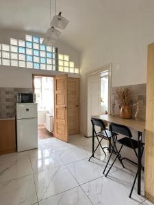 a kitchen with a table and two chairs at Templomdomb apartman in Kővágóörs