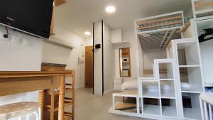 a small room with a bunk bed and a desk at Estudio vistas al Veleta Parking Gratis in Monachil