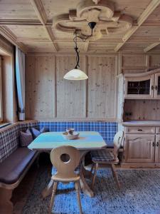 a dining room with a table and a couch at Fankhauser Apartments - am Berg in Ried im Zillertal +19 photos