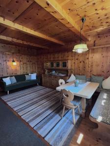 a room with a table and a couch and a kitchen at Fankhauser Apartments - am Berg in Ried im Zillertal