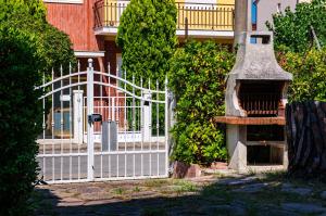 a white fence in front of a house at La Casa di Sara in Marcelli