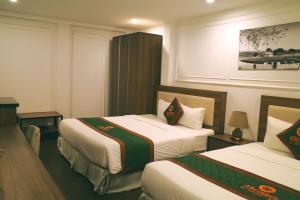 a hotel room with two beds in a room at AS Hotel Đà Lạt in Da Lat
