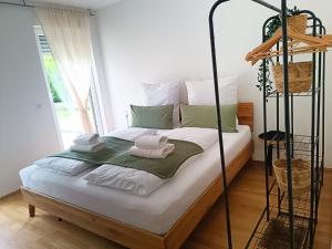 a bedroom with a bed with towels on it at Stilvolleauszeit mit Garten - 15 min bis Köln in Hürth