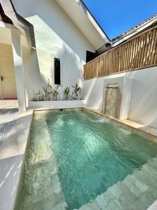 a swimming pool in the middle of a house at Villa Mawar Lombok in Kuta Lombok