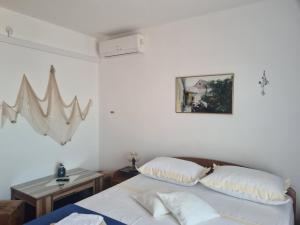 Łóżko lub łóżka w pokoju w obiekcie Rooms Raos