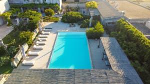 an overhead view of a swimming pool on top of a building at Masseria Borgo Sentinella in Torre dell'Orso