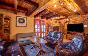 a living room with leather furniture and a flat screen tv at Holiday Home Dubranec by Villas Guide in Dubranec