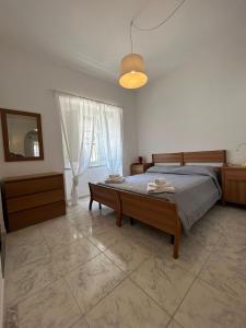 a bedroom with a bed with a table and a mirror at Green Appartament in Marina di Camerota