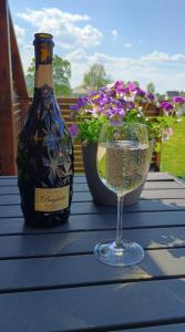 a bottle of wine and a glass on a table at Small farm in Bjørheimsbygd, 30 min from Preikestolen in Strand